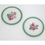 A pair of cabinet plates , having green and gilt borders with floral decoration to centre. 9''