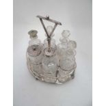A silver plate 6 bottle cruet stand by HG Long & Co . The stand of ovoid form with shield to sides