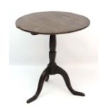 An 18thC circular tilt top tripod table with hexagonal shaped column 25 1/4" diameter x 27" high