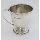 A silver Christening mug with pedestal foot and loop handle. Hallmarked Birmingham 1953 maker Joseph