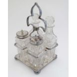 A silver plate four bottle cruet stand with cut glass bottles. The whole 7" high  CONDITION: