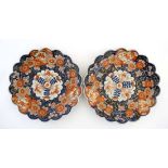 A pair of C1900 Japanese Imari plates, having scalloped edge and central floral motif, decorated
