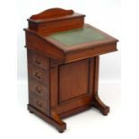 An early 20thC mahogany Davenport with gold tooled green leather insert and four drawers 34 1/4"