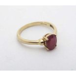 A 9ct gold ring set with oval cut ruby solitaire CONDITION: Please Note -  we do not make