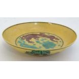 An Imperial yellow  '' dragon '' dish , decorated with two 5 clawed dragons fighting over a
