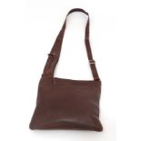 A Genuine Ladies Radley cross the body messenger leather oxblood colour bag, having two pockets to