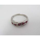 A silver ring set with 5 pink stones and 4 chip set diamonds CONDITION: Please Note -  we do not