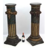 A pair of faux marble , wooden columns with carved and gilded floral swags. 44 1/2'' high.