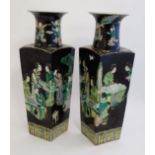 A pair of Famille Noir wucai vases of square tapering form with flared rim , decorated with figures,
