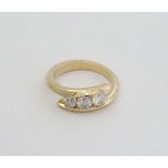 A yellow metal ring set with three graduated diamonds CONDITION: Please Note -  we do not make