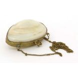 A Victorian ladies clam shell evening purse, with gilt coloured metal frame, closure and chain