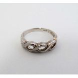 A silver ring with open work decoration CONDITION: Please Note -  we do not make reference to the