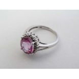 A 9ct gold ring set with central pink stone
 CONDITION: Please Note -  we do not make reference to