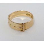 A 15ct gold ring with belt and buckle decoration. Maker C.N Birmingham (4g)
 CONDITION: Please