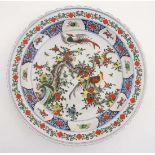 A Chinese famille verte charger, decorated with hand painted birds in flowering boughs. 17 3/4''