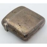 A silver vesta case of shaped form with hinged lid and striker under. Hallmarked Birmingham 1903