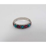 An 18ct white gold ring set with 4 rubies and 3 turquoise cabochon in a linear setting