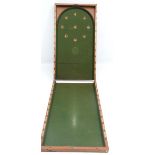 A traditional late 19thC folding bagatelle board having green baise lining to base. 48'' x 27''.