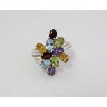 A silver dress ring, set with various coloured stones including amethysts, garnets etc.