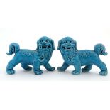 A pair of Chinese blue glazed Yin and Yang ceramic Dogs of Fo, one bears indistinct makers mark to