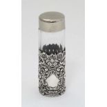 An early 20thC silver scent bottle sleeve with pierced and embossed decoration, maker Henry