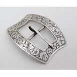 A shaped belt buckle with engraved decoration. Marked Sterling and numbered 2592  2 3/4"