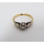 An 18ct gold ring set diamond solitaire with engraved decoration to shoulders.  CONDITION: Please