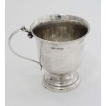 A silver Christening mug with pedestal foot and loop handle. Hallmarked Birmingham 1951 maker Deakin