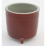 A Chinese Sang De Beouf three legged cylindrical pot. 6'' high. CONDITION: Please Note -  we do