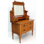 Maple & Co : An Art Nouveau satin walnut dressing table with bevelled mirror.   Marked with Reg