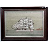 Ship's Woolwork : a 19thC three masted sailing ship passing a lighthouse at sea, 17 3/4 x 26 3/4"