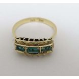 An 18ct gold ring set with 3 graduated baguette cut emeralds 
 CONDITION: Please Note -  we do not