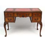 An early - mid 20thC ladies writing table  with serpentine shaped front and with tooled red