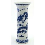 A Chinese blue and white cylinder vase with flared rim and base, decorated with 5 claw dragons