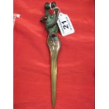 AN UNUSUAL BRASS LETTER OPENER with stylised handle in the form of a couple embracing, 8", in the