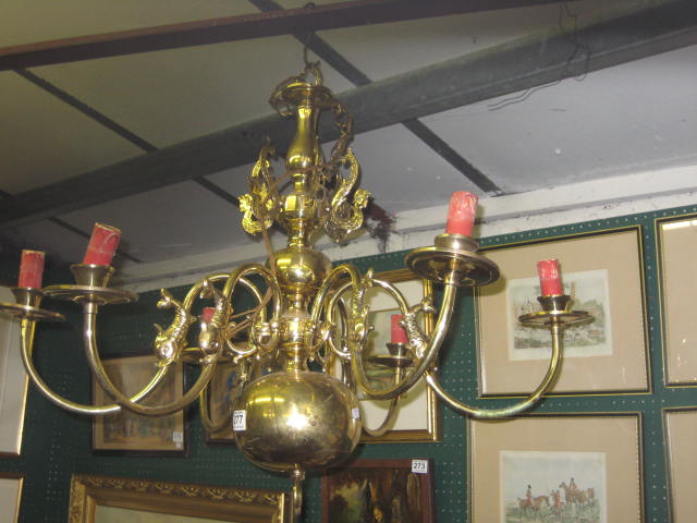 AN ALL BRASS SIX BRANCH CHANDELIER with turned and bulbous column and downswept candle holders