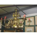 AN ALL BRASS SIX BRANCH CHANDELIER with turned and bulbous column and downswept candle holders