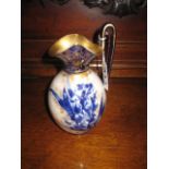 A POTTERY JUG with blue and white iris design and gilt overlay, 7.5", Doulton Burslem (restored)