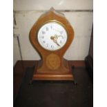 A MANTLE CLOCK having a circular enamel dial with Arabic numerals, key wind pendulum movement, in an
