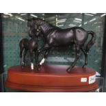 A MODEL, 'Black Beauty and Foal', on a wooden plinth base, 9.25" high overall, Beswick