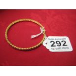 A LADIES YELLOW GOLD BANGLE (tested to 18 Carat)