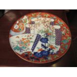 A POTTERY CHARGER/PLAQUE decorated with birds, chrysanthemums, prunus blossom etc, 18.5" diameter,