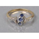 * Ring. A sapphire and diamond ring set in gold with three small aligned sapphires with flanked by