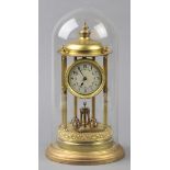 * Anniversary Clock. An early 20th century brass mantel clock, the circular enamel dial with