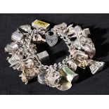 * Charm Bracelet. A substantial modern silver charm bracelet with approx. thirty-five charms