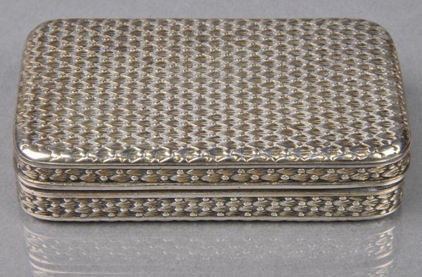 * Snuff Box. A George III silver oblong snuff box, chased with a repeating geometric decoration