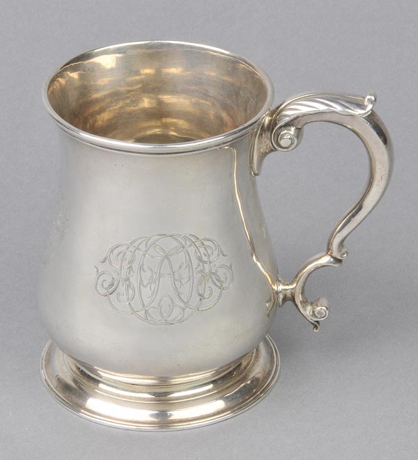 * Silver Mug. A George II silver baluster mug, engraved with an armorial and greyhound courant of