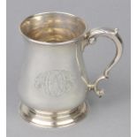 * Silver Mug. A George II silver baluster mug, engraved with an armorial and greyhound courant of