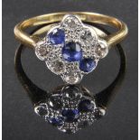 * Ring. An 18ct gold and platinum ring, the square illusion setting with three central sapphires