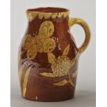 North Devon Jug. A large early 20th century Bideford pottery slipware jug, with yellow sgraffito